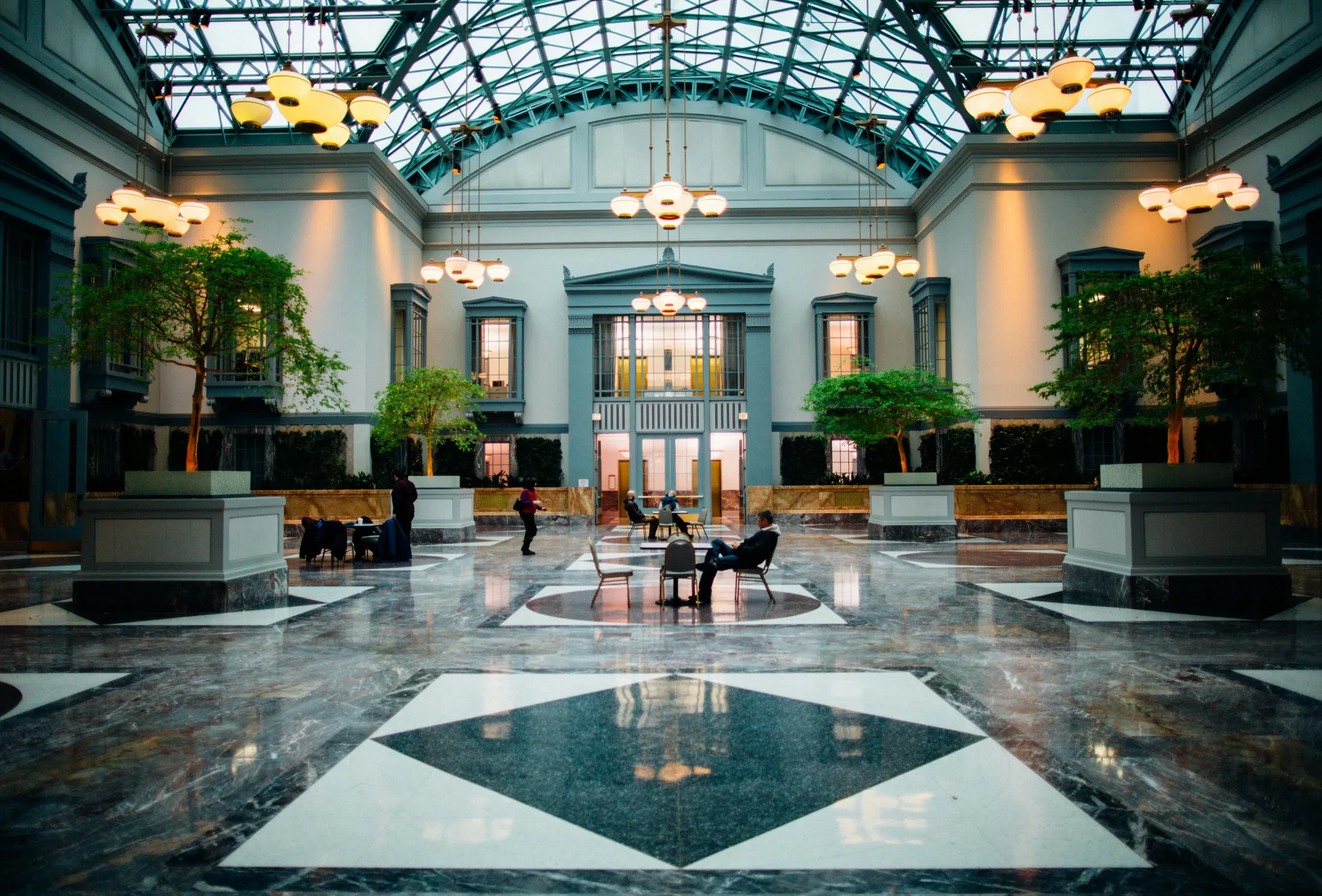 Elegant hotel atrium with glass ceiling and marble floors